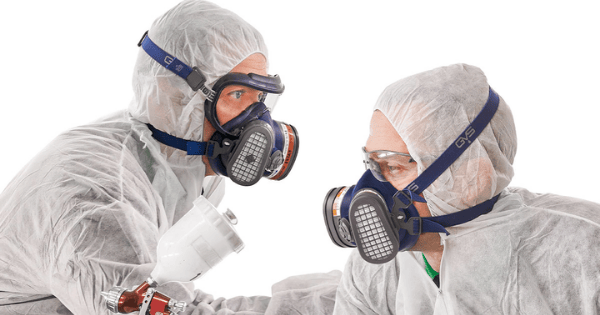 Professionals in protective gear using GVS Malaysia respirators.